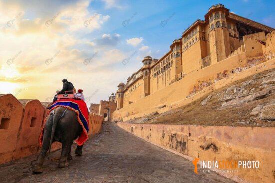 Tourist enjoy elephant ride at Amer Fort Jaipur at sunrise