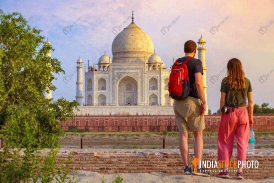 Couple enjoy Taj Mahal sunset view from Mehtab Bagh