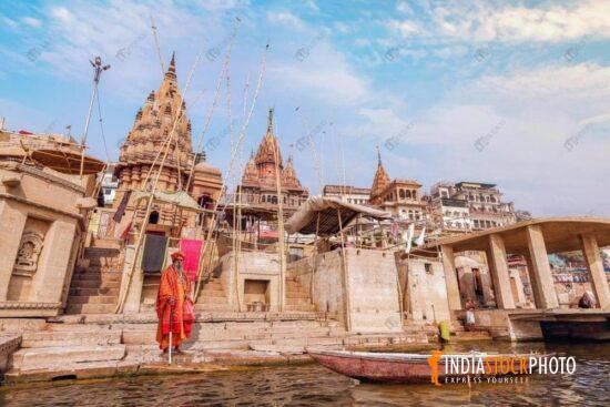 Sadhu standing at Ganges river ghat Varanasi