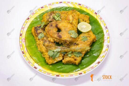 Bengali cuisine Rohu fish masala curry served on banana leaf