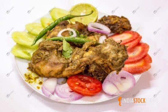 Bengali cuisine spicy dry chicken dish served with salad