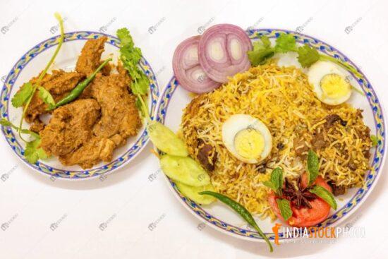 Indian meal of chicken biriyani with mutton kosha side dish