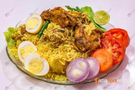 Spicy chicken biriyani rice with sliced eggs and garnished with vegetables