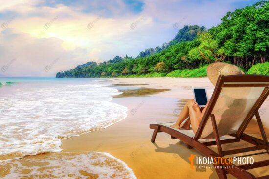 Female tourist relax on a beach chair at Havelock islands sea beach Andaman