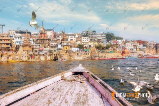 Ancient Varanasi city architecture with migratory birds on river Ganges