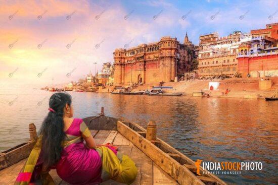 Indian woman enjoy boat ride at Varanasi Ganges at sunset