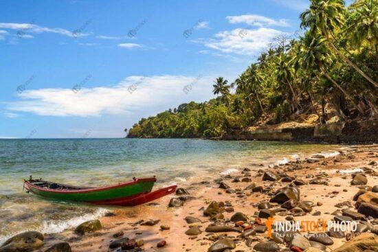 Scenic Ross island sea beach with wooden boat at Andaman