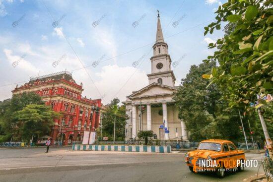 Yellow cab on city road with ancient colonial city architecture at Kolkata