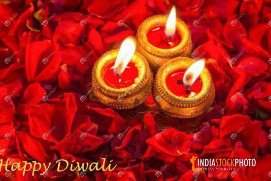 Diwali background of clay diya lamps with rose petals