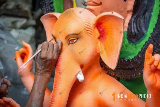 Artist hand working on Lord Ganesha idol at Kolkata