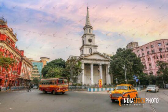 Ancient city buildings with traffic on city road at sunrise at Kolkata