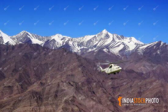 Helicopter flies over the Himalaya range at Ladakh India