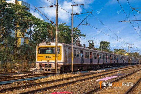 Local train of Indian Railways with train tracks