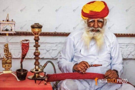 Aged man smoking a pipe at Mehrangarh Fort at Jodhpur