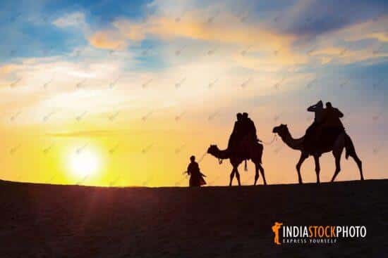 Tourist camel safari at Thar desert Jaisalmer Rajasthan at sunset