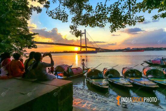 Vidyasagar setu bridge with boats at Princep Ghat Kolkata at sunset