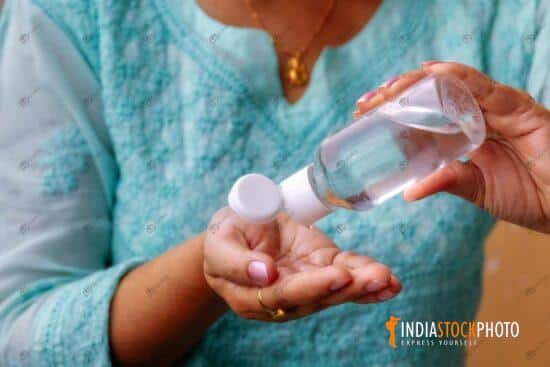 Woman hands pouring hand sanitizer as Covid-19 awareness