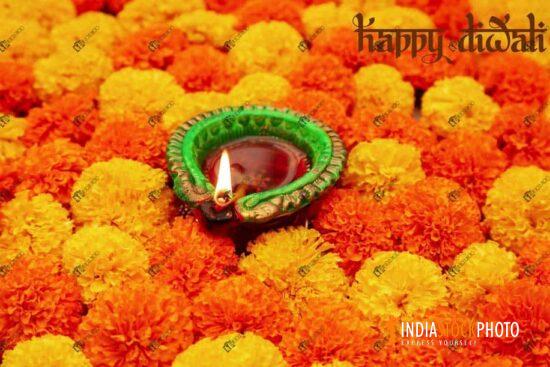 Diwali clay Diya lamp on marigold flowers for Diwali decoration