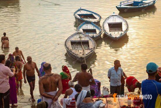 Varanasi Ganges river ghat with pilgrims at sunrise