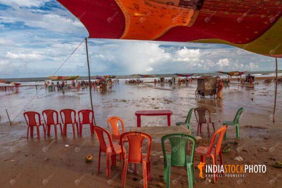 Indian sea beach with empty plastic chairs at a beach stall
