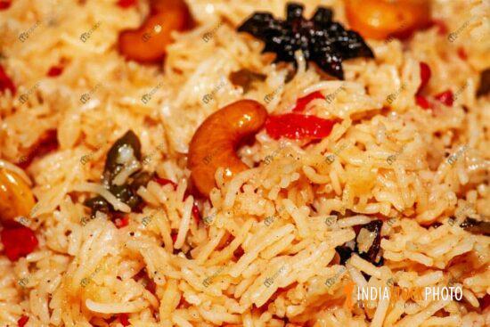 Spicy Indian fried rice cuisine with cashew nuts in macro view