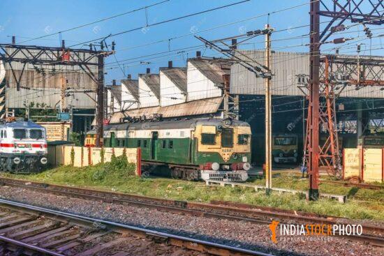 Indian local train and diesel engine near railway loco shed