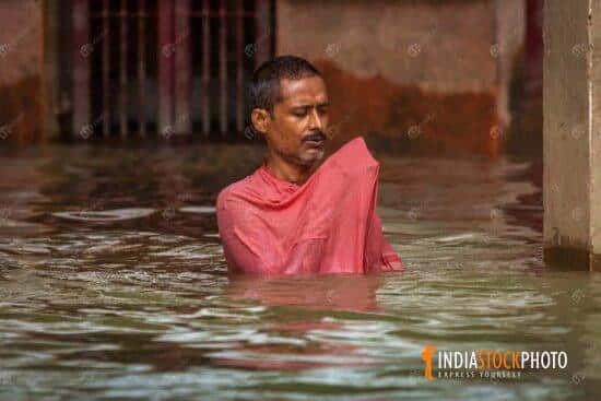 Man meditating while immersed in river Ganges at Varanasi