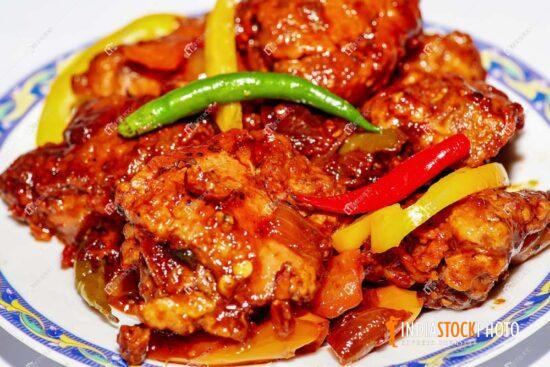 Spicy chicken food with tomato and green chili