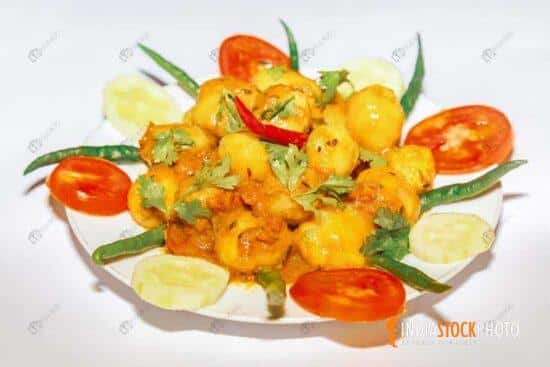 Spicy vegetarian food prepared with potatoes garnished with salad