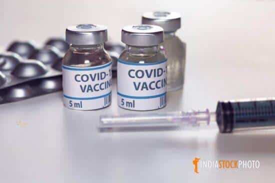Covid 19 vaccine bottles with injection syringe