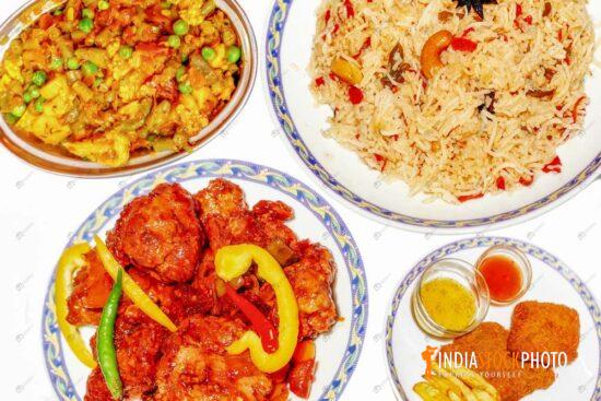 Indian meal of fried rice manchurian chicken paneer masala and fish fries