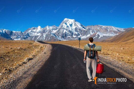 Tourist backpacker on Himalaya mountain road North Sikkim