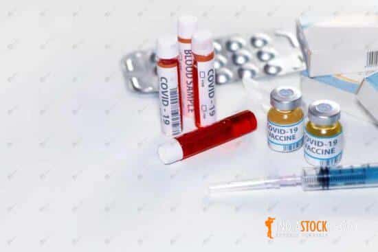 Covid 19 vaccine bottles with blood sample vials