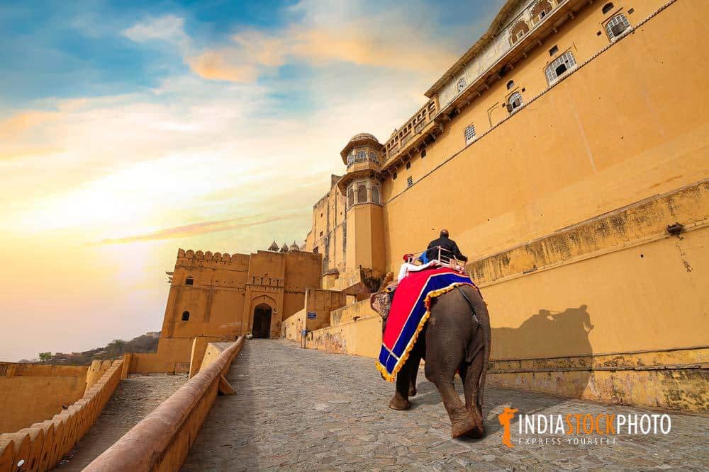 Amer Fort at Jaipur Rajasthan with tourist enjoying an elephant ride at sunset