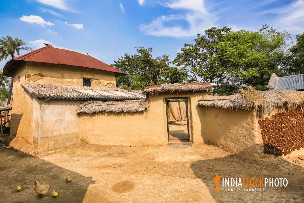 Mud hut with poultry in the courtyard at an Indian village in West Bengal