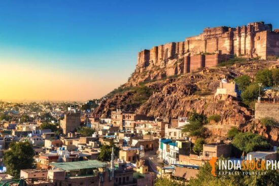 Mehrangarh Fort on top of a cliff with Jodhpur cityscape at sunset